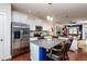 Kitchen features granite countertops, stainless steel appliances, an island, and flows into the living space at 7809 Lillyhurst Dr, Raleigh, NC 27612