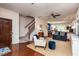 Inviting living room with hardwood floors, a staircase, comfortable seating, and an open floor plan at 7809 Lillyhurst Dr, Raleigh, NC 27612
