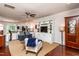 Open-concept living area flowing into the kitchen with neutral color scheme and hardwood flooring throughout the space at 7809 Lillyhurst Dr, Raleigh, NC 27612