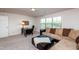 Comfortable living room featuring a plush sectional sofa, desk, and soft ambient lighting at 7809 Lillyhurst Dr, Raleigh, NC 27612
