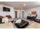Open living room featuring a plush sectional sofa, desk, and warm ambient lighting at 7809 Lillyhurst Dr, Raleigh, NC 27612