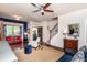 Spacious living room featuring a sitting area and view of the front door and staircase with an overhead ceiling fan at 7809 Lillyhurst Dr, Raleigh, NC 27612