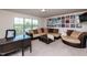 Comfortable living room featuring a plush sectional sofa, desk, and large window with pleasant views at 7809 Lillyhurst Dr, Raleigh, NC 27612