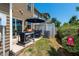 Cozy patio with grill, seating area, and small yard at 7809 Lillyhurst Dr, Raleigh, NC 27612