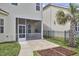 Serene backyard with a screened porch, lush lawn, and a beautiful palm tree at 808 Historian St, Raleigh, NC 27603