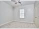 Cozy bedroom featuring neutral walls, plush carpet, ceiling fan, and natural light from the window at 808 Historian St, Raleigh, NC 27603