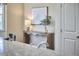 Console table with a lamp sits next to the breakfast nook with lots of natural light at 808 Historian St, Raleigh, NC 27603