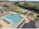 Aerial view of a large community pool, tennis court, and playground, offering residents diverse recreational options at 808 Historian St, Raleigh, NC 27603