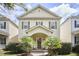 Inviting two-story home with a covered porch, shutters, and lovely landscaping at 808 Historian St, Raleigh, NC 27603