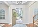 Bright foyer with wood floors, adjacent to the staircase with natural light at 808 Historian St, Raleigh, NC 27603