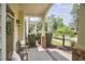 Charming covered porch with neutral furniture and beautiful brick accents at 808 Historian St, Raleigh, NC 27603