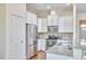 Well-lit kitchen boasts stainless steel appliances, granite countertops, and white cabinetry at 808 Historian St, Raleigh, NC 27603