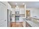 Well-appointed kitchen with stainless steel appliances, granite counters, and white cabinetry at 808 Historian St, Raleigh, NC 27603