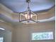 Elegant light fixture hangs from the ceiling, accenting the tray ceiling at 808 Historian St, Raleigh, NC 27603