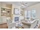 Comfortable living room with built-in shelving flanking a fireplace and lots of natural light at 808 Historian St, Raleigh, NC 27603