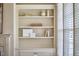 Built-in shelving unit with cabinets in a light, neutral living room at 808 Historian St, Raleigh, NC 27603