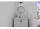 Stylish powder room with a round mirror, vessel sink, and modern lighting at 810 Culpepper Ln, Raleigh, NC 27610