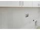 Bright laundry room with white cabinets and utility connections at 810 Culpepper Ln, Raleigh, NC 27610