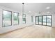 Bright, airy living room with hardwood floors, modern lighting, and sliding doors to the backyard at 810 Culpepper Ln, Raleigh, NC 27610