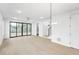 Bright living room with light wood floors, a modern ceiling fan, and sliding glass doors at 810 Culpepper Ln, Raleigh, NC 27610