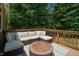 Inviting outdoor deck with comfortable seating and a modern fire pit at 90 Weatherly Dr, Franklinton, NC 27525