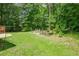 Lush green backyard featuring an outdoor seating area, perfect for relaxation and entertaining guests at 90 Weatherly Dr, Franklinton, NC 27525