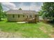 Expansive backyard showcasing a deck, patio, and large grassy area for outdoor activities at 90 Weatherly Dr, Franklinton, NC 27525