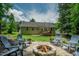 Home exterior with stone firepit in the backyard, complete with seating at 90 Weatherly Dr, Franklinton, NC 27525