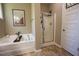 Elegant bathroom with a soaking tub, tiled floor and separate glass shower at 90 Weatherly Dr, Franklinton, NC 27525
