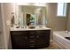 Bright bathroom with a double vanity, decorative accents, and a large mirror at 90 Weatherly Dr, Franklinton, NC 27525