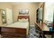 Cozy bedroom features a wooden bed, desk and chair plus wall art at 90 Weatherly Dr, Franklinton, NC 27525