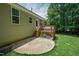 Exterior back of home with deck, stone patio, and landscaped yard at 90 Weatherly Dr, Franklinton, NC 27525