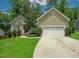 Charming home with a well-manicured lawn and a two-car garage, offering great curb appeal at 90 Weatherly Dr, Franklinton, NC 27525