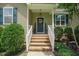 Inviting front entrance with brick steps, decorative door, and well-maintained landscaping creating a warm welcome at 90 Weatherly Dr, Franklinton, NC 27525