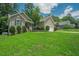 Beautifully landscaped front yard with lush green grass and manicured shrubbery enhancing the curb appeal of the home at 90 Weatherly Dr, Franklinton, NC 27525