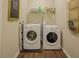Functional laundry room with washer, dryer, storage, and ironing board at 90 Weatherly Dr, Franklinton, NC 27525