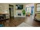 Open-concept living room featuring hardwood floors, fireplace, and view of dining area at 90 Weatherly Dr, Franklinton, NC 27525