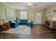 Stylish living room featuring a comfortable blue sectional sofa, hardwood floors, and a bright, airy atmosphere at 90 Weatherly Dr, Franklinton, NC 27525