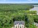 Scenic aerial view of townhomes near a lake and surrounded by verdant trees at 907 Lake Beacon Way, Raleigh, NC 27606