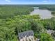 Aerial view of townhomes surrounded by lush greenery with a lake in the background at 907 Lake Beacon Way, Raleigh, NC 27606