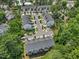 Aerial view of a neighborhood with well-maintained townhomes and mature trees at 907 Lake Beacon Way, Raleigh, NC 27606