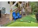 Backyard features artificial turf, blue chairs, and a staircase leading to the upper level at 907 Lake Beacon Way, Raleigh, NC 27606