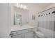 Bathroom featuring a vanity with a sink, gold hardware, and a shower/tub combo with curtain at 907 Lake Beacon Way, Raleigh, NC 27606