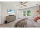 Bedroom featuring a dresser with a TV on top, a ceiling fan, wooden floors, and natural light at 907 Lake Beacon Way, Raleigh, NC 27606