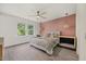 Bedroom with a decorative ceiling fan, wooden floors, and a pink accent wall with a queen size bed at 907 Lake Beacon Way, Raleigh, NC 27606