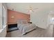 Bedroom with a decorative ceiling fan, wooden floors, a pink accent wall and a queen size bed at 907 Lake Beacon Way, Raleigh, NC 27606