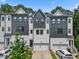 Modern townhome featuring a gray and white color scheme and an attached two-car garage at 907 Lake Beacon Way, Raleigh, NC 27606