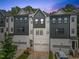 Modern townhome featuring a gray and white color scheme and an attached two-car garage at 907 Lake Beacon Way, Raleigh, NC 27606
