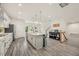 Spacious kitchen featuring gray wood floors, an island, and stainless steel appliances at 907 Lake Beacon Way, Raleigh, NC 27606