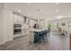 Modern kitchen with large island, sleek stainless steel appliances, and stylish pendant lighting at 907 Lake Beacon Way, Raleigh, NC 27606
